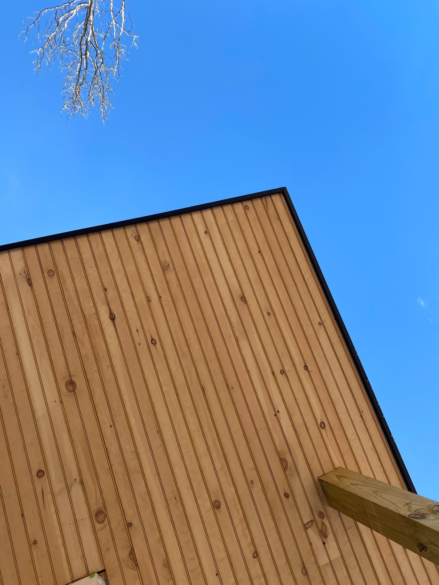 Wooden roof against a clear blue sky